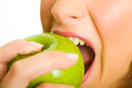 Woman biting green apple